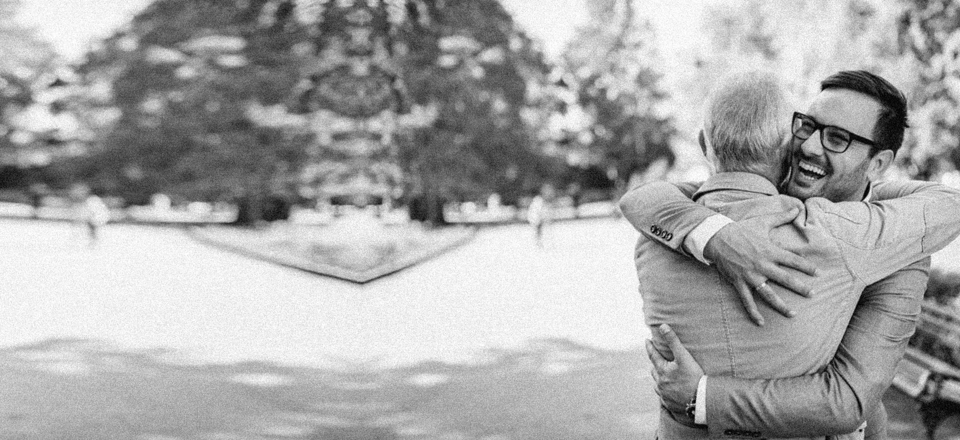 happy man hugging father after online outpatient treatment for substance abuse